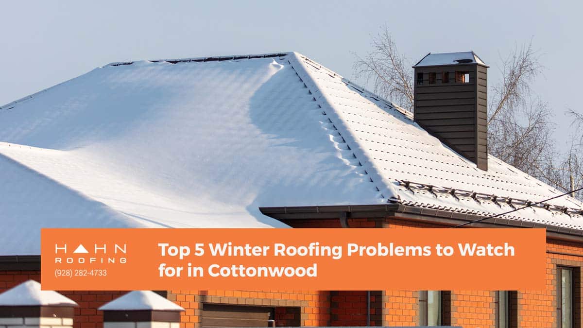 A snow-covered roof with a chimney in Cottonwood, illustrating winter roofing challenges. From the blog post "Top 5 Winter Roofing Problems to Watch for in Cottonwood" by Hahn Roofing.