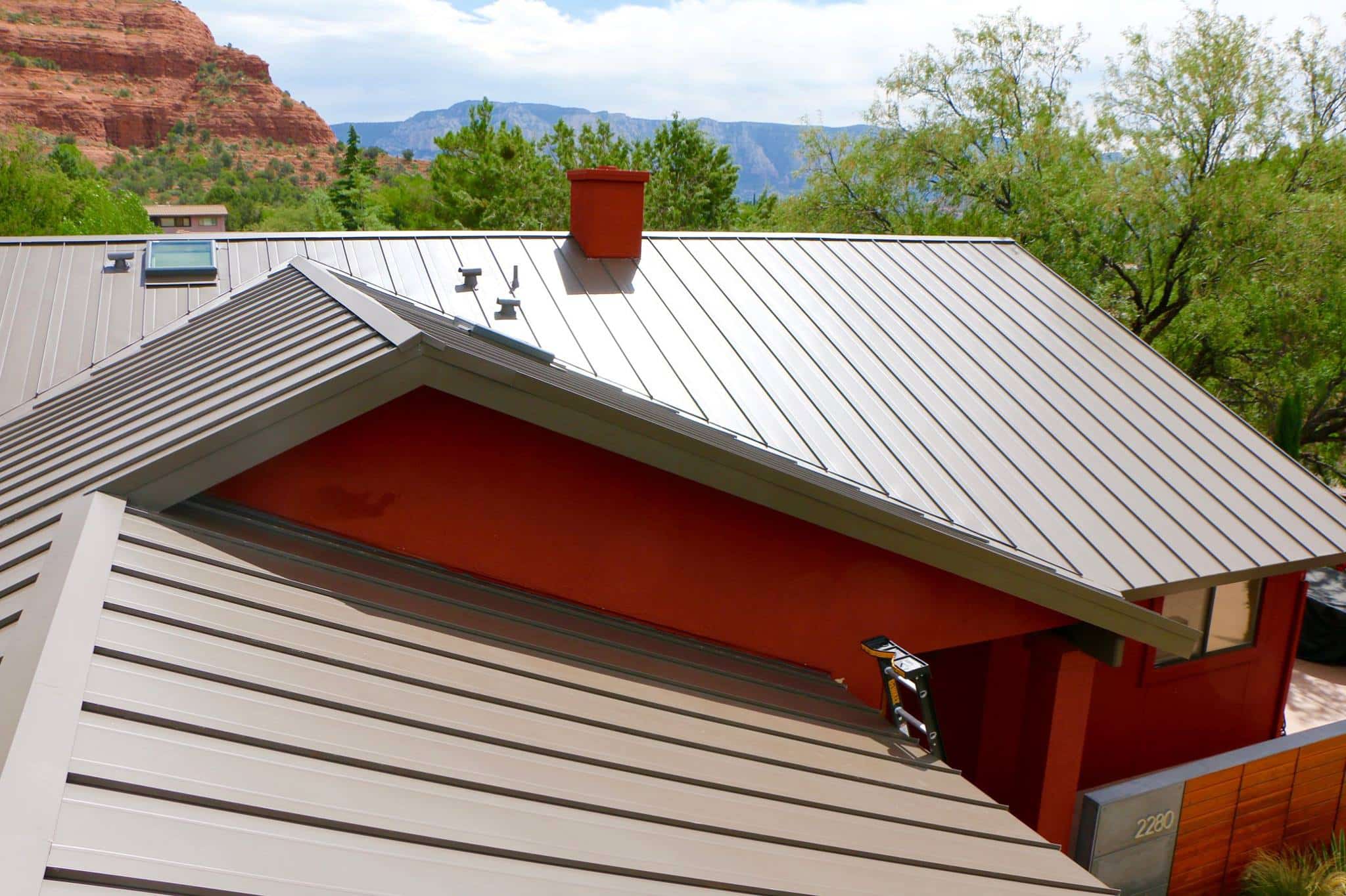 A metal roof on a home in Sedonas Arizona. This image helps illustrate that there are several different types of roofing materials available.