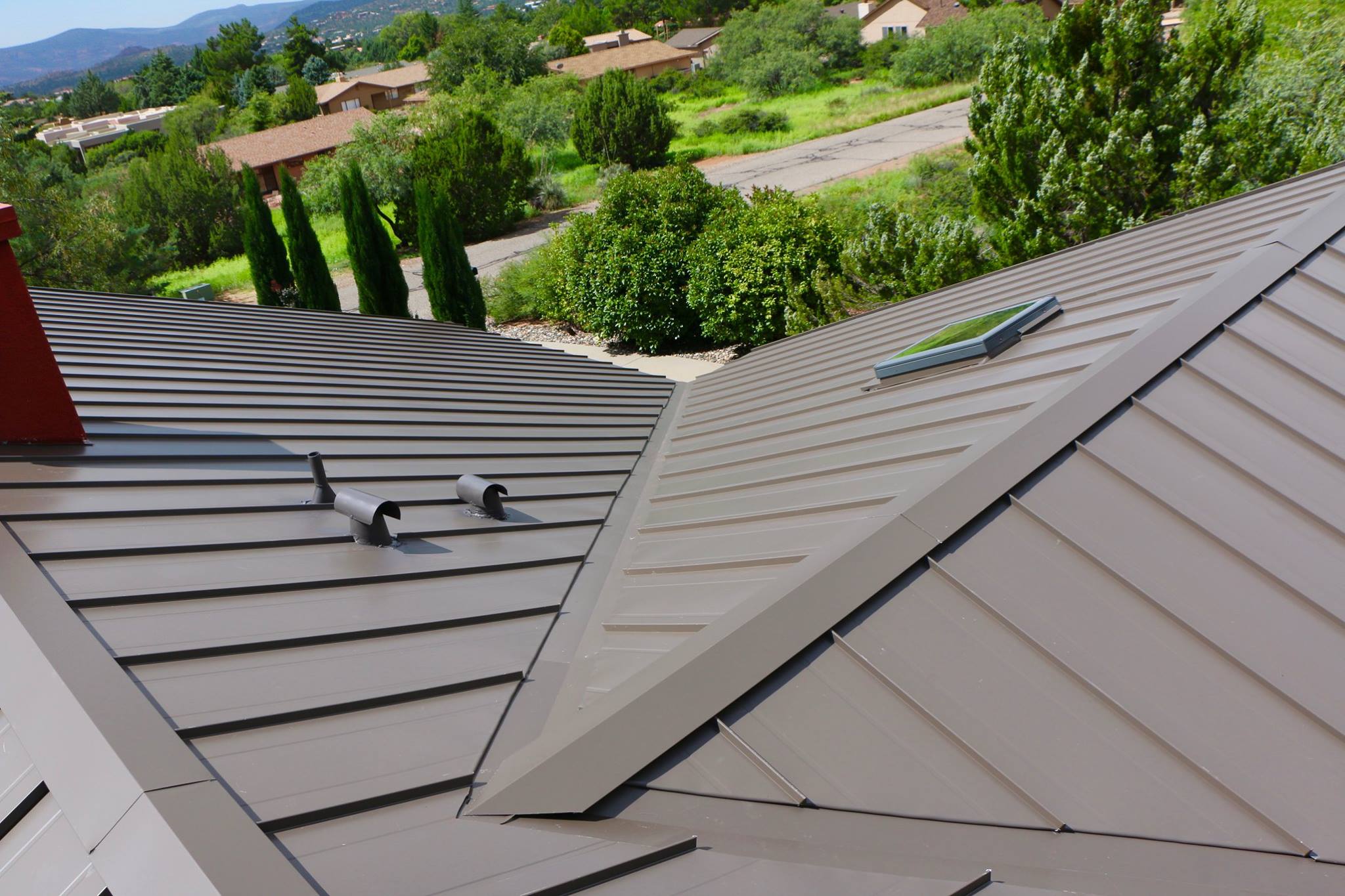 A metal roof on a home in Sedonas Arizona. This image helps illustrate that there are several different types of roofing materials available.