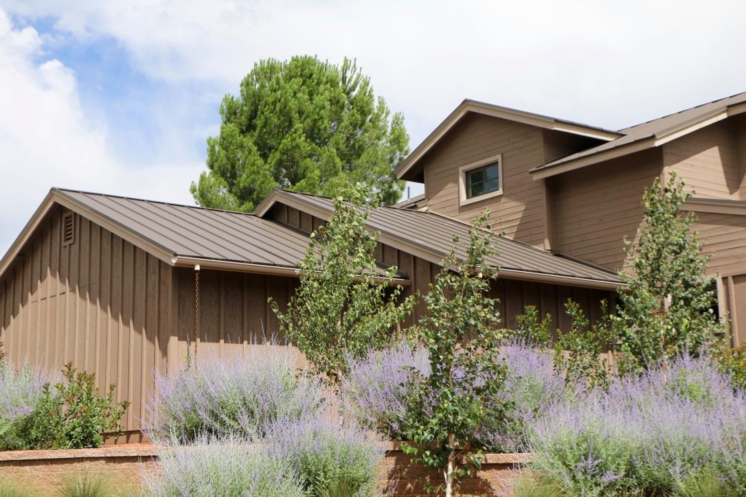 A metal roof on a home in Sedonas Arizona. This image helps illustrate that there are several different types of roofing materials available.