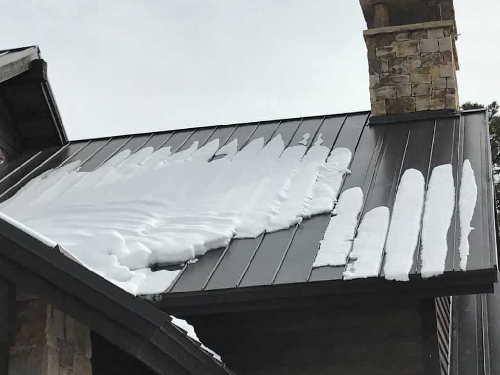 A metal roof on a home in Sedonas Arizona. This image helps illustrate that there are several different types of matal roofing materials available.