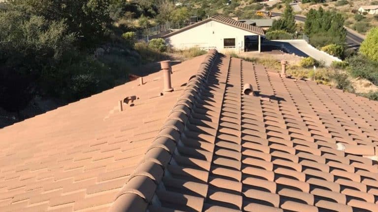 A close-up view of a terracotta-tiled roof on a Cottonwood home, overlooking a residential area. From Hahn Roofing's "7 Fall Roofing Tips to Protect Your Cottonwood Home."