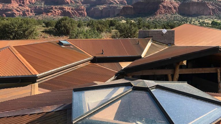 Energy-Efficient-Roofing-Options-for-Camp-Verde-Homes-Saving-Money-and-Staying-Cool-with-text.jpg Alt Tag: An expansive Camp Verde property with rust-colored metal roofs blending into the desert landscape. Connected to Hahn Roofing's "Energy-Efficient Roofing Options for Camp Verde Homes: Saving Money and Staying Cool."