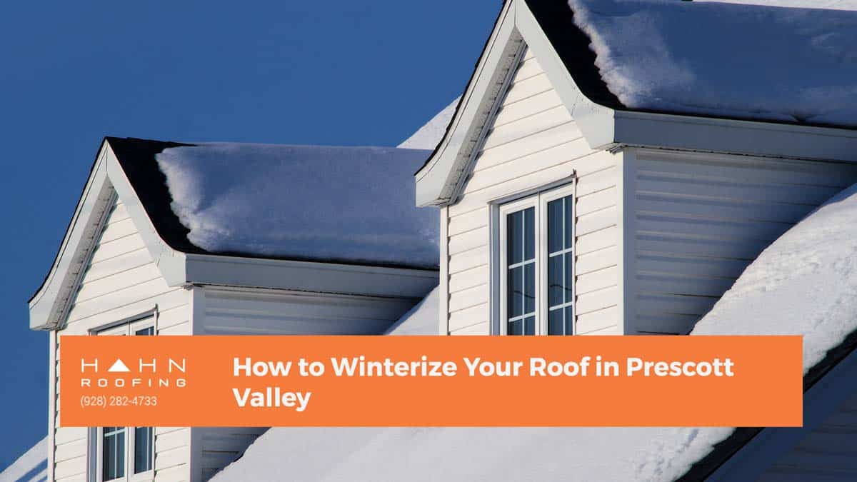 A snow-covered white house in Prescott Valley, emphasizing winterizing techniques. From the blog post "How to Winterize Your Roof in Prescott Valley" by Hahn Roofing.