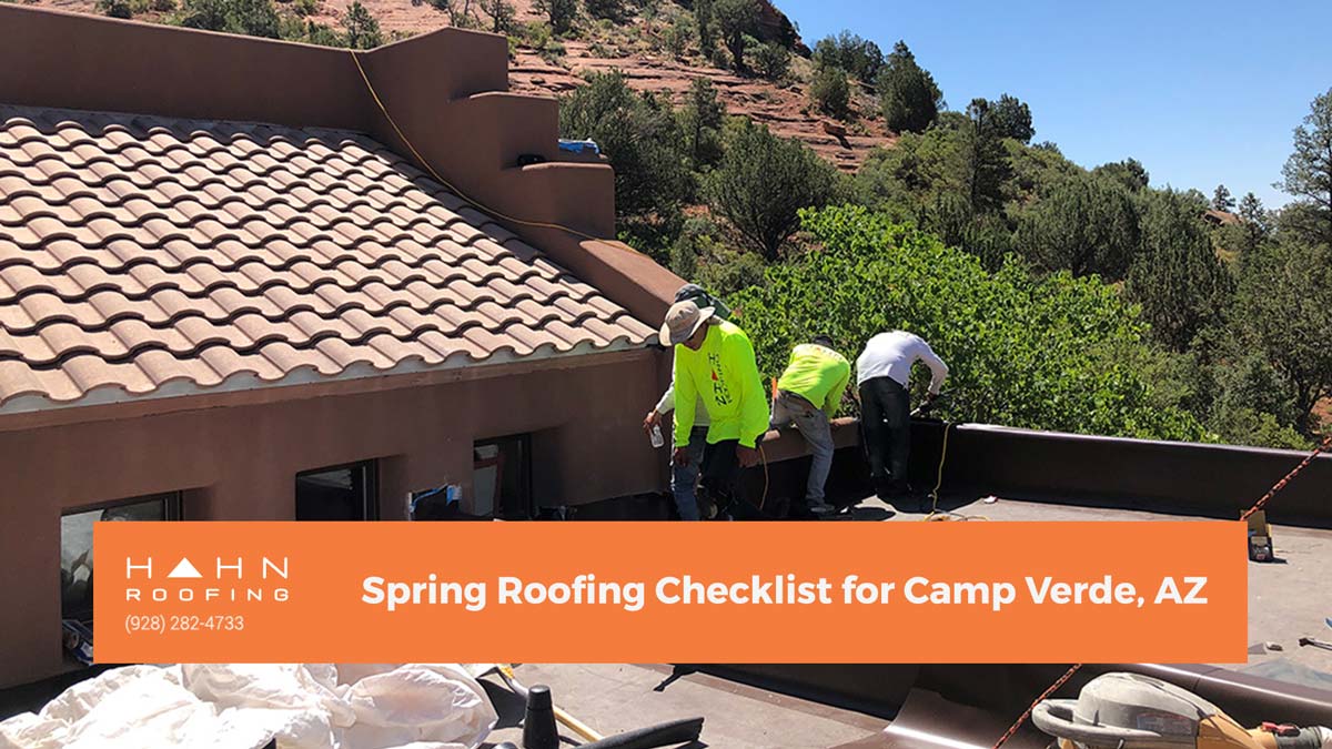 A team of roofers working on a tile roof with Camp Verde's natural landscape in the background. From the blog post "Spring Roofing Checklist for Camp Verde, AZ" by Hahn Roofing.