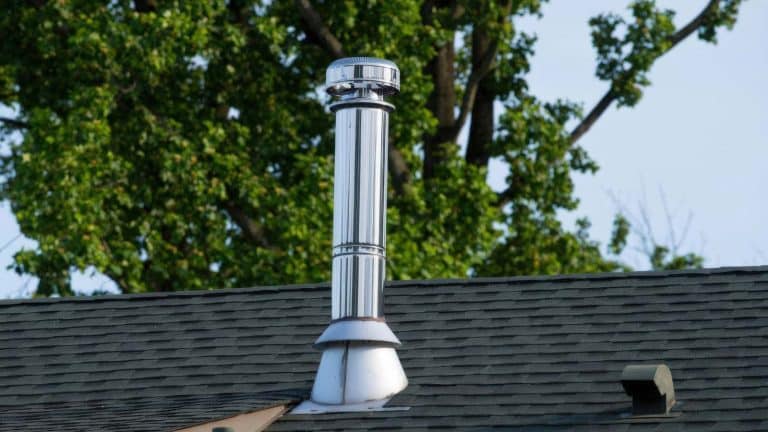 A rooftop ventilation system surrounded by greenery in Camp Verde, highlighting its importance for home health. From the blog post "Why Roof Ventilation is Key for Your Camp Verde Home's Health" by Hahn Roofing